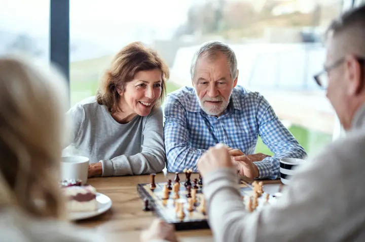 Friends playing chess over coffee