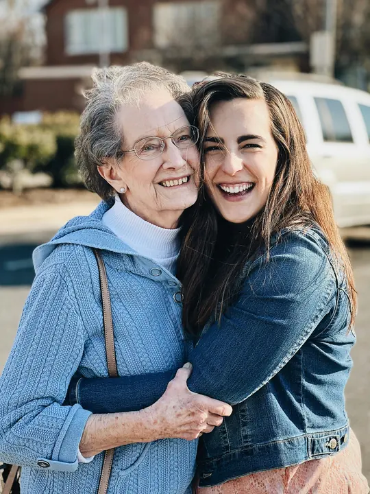 A young woman hugging her smiling mother