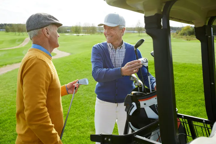 Two men chatting on a golf course